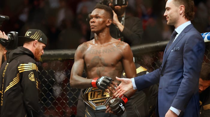 Feb 12, 2022; Houston, Texas, UNITED STATES; Israel Adesanya (red gloves) reacts after the fight against Robert Whittaker (blue gloves) during UFC 271 at Toyota Center.